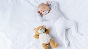 édes kisbaba cumizik az ágyban alszik