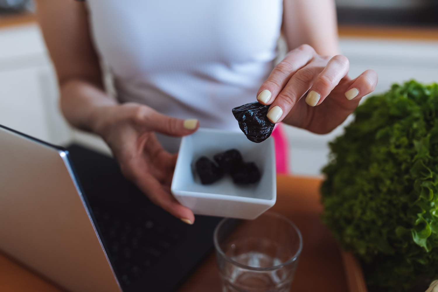 Egy nő aszalt szilvát eszik