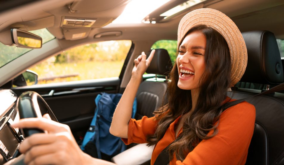 szerencsés nő örül vezetés közben a 2026-os horoszkópjának