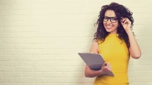 sárga ruhás nő áll a fal előtt