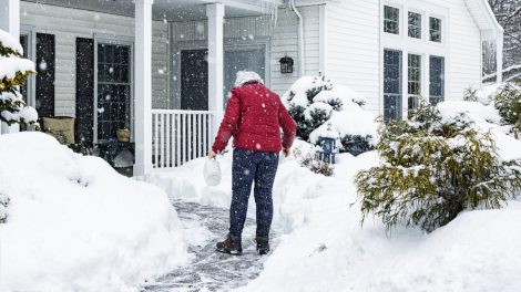 nő csúszkál havas időben a kocsibehajtón