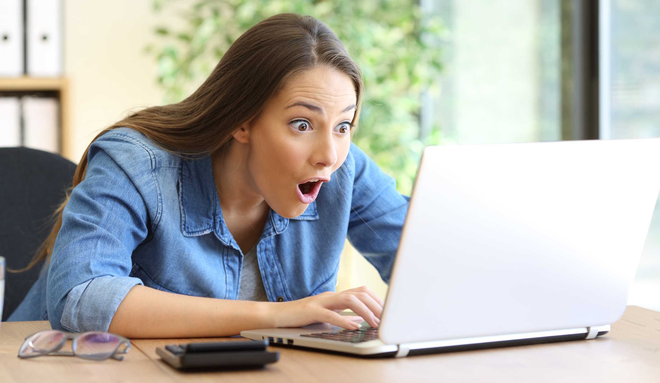 Nő a laptopján néz valamit és nagyon meglepődik