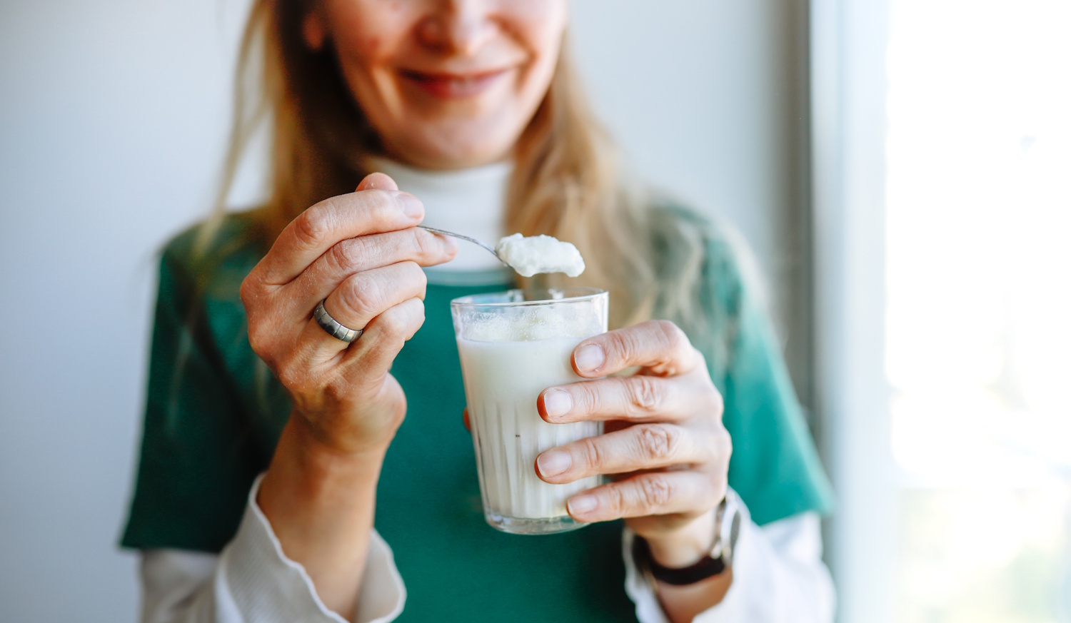 Joughurtot eszik egy nő