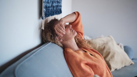 Egy nő fekszik a kanapén