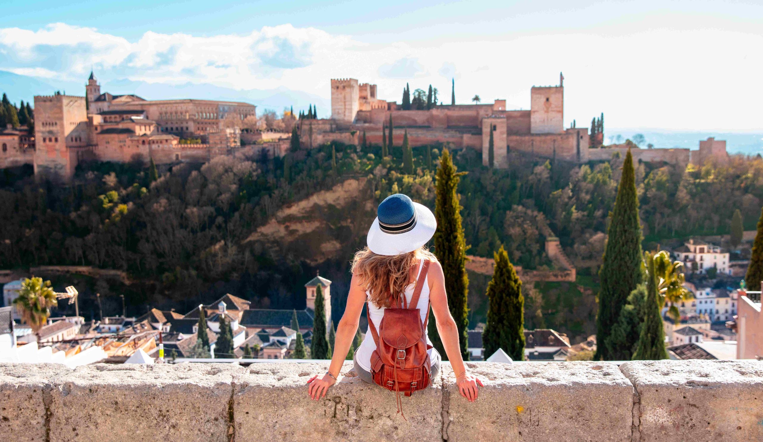 Turista nő az Alhambra ősi arab erődítményét nézi Granadában, Spanyolországban