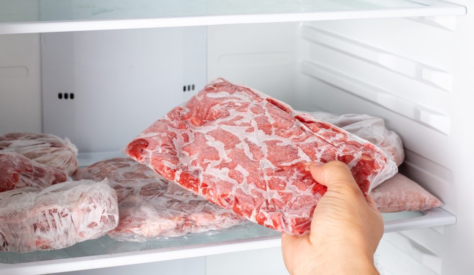 Closeup of hand choosing fresh raw meat in the freezer Frozen food | Meglepetés fagyasztott húst vesz ki egy nő a fagyasztóból